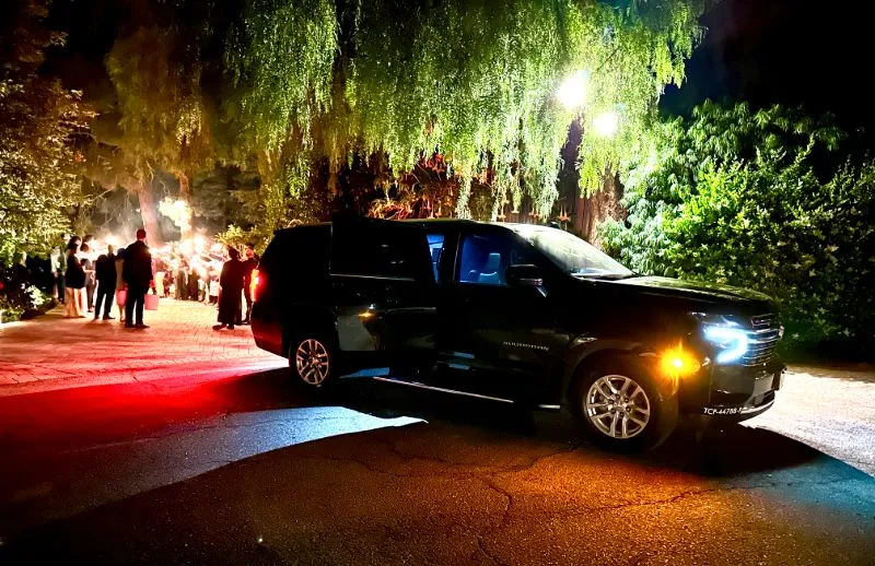 Black SUV at an evening event